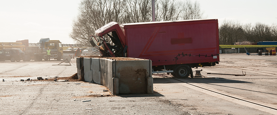 Picture of a truck crashing into a KarabloK barrier in a standards test