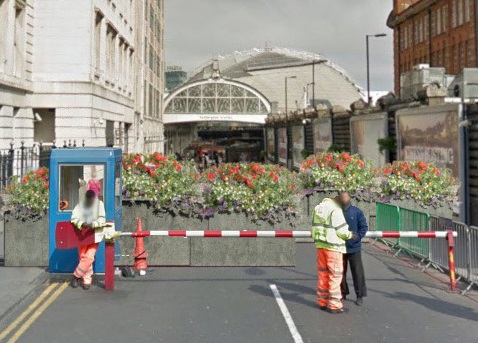 A close-up of a computer generated image of the entrance to Paddington Station with a KarabloK hostile vehicle mitigation barrier - planted with flowers - protecting it